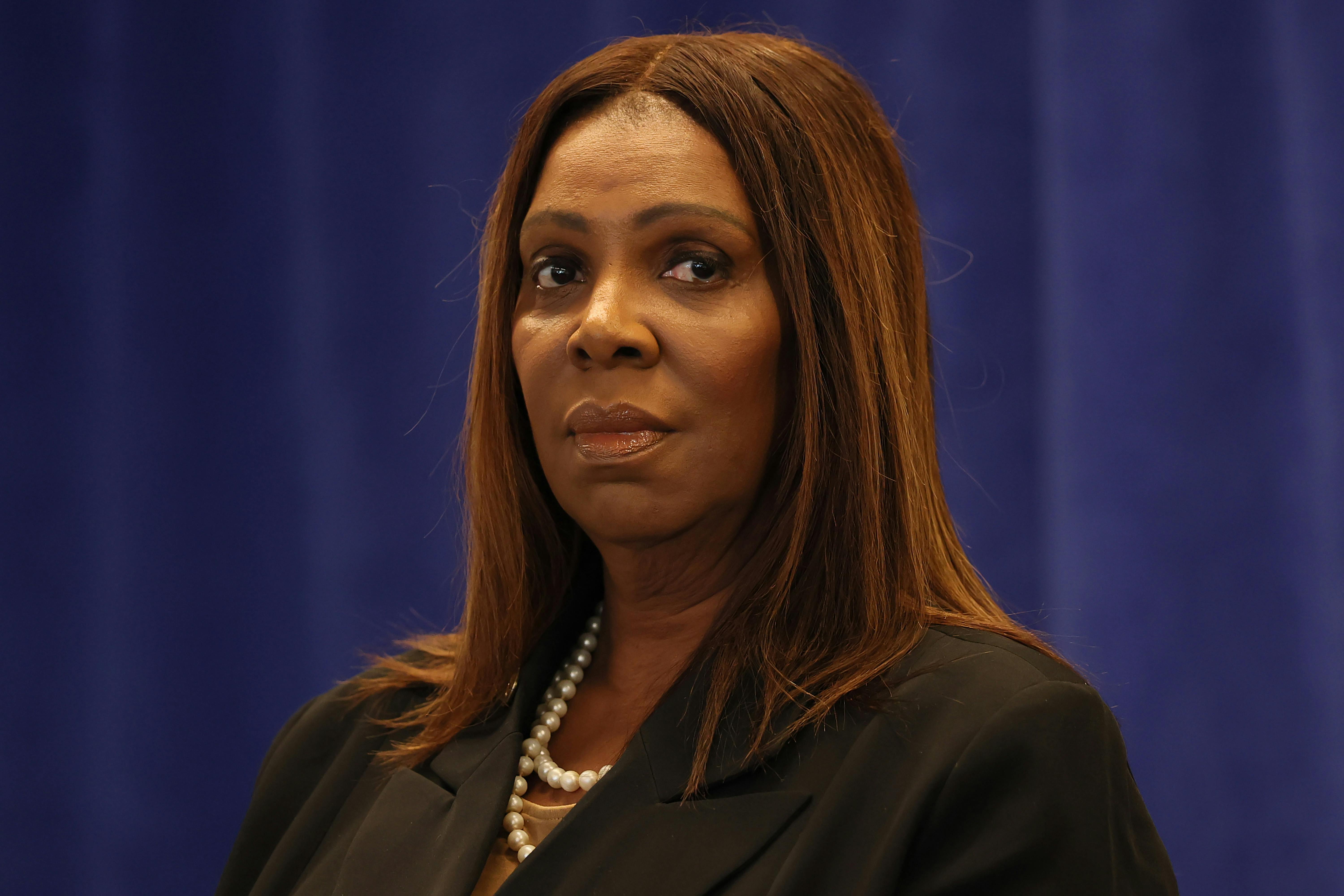 New York Attorney General Letitia James looks to the side while standing during a press conference