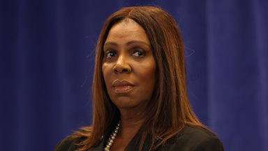 New York Attorney General Letitia James looks to the side while standing during a press conference