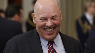 U.S. Postmaster General Louis DeJoy smiles.