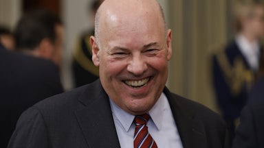 U.S. Postmaster General Louis DeJoy smiles.