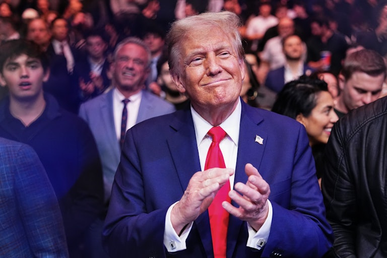 Donald Trump smiles and claps