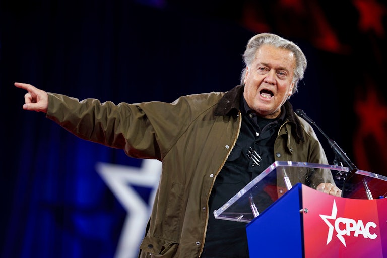 Steve Bannon points while speaking animatedly at a lectern at CPAC.