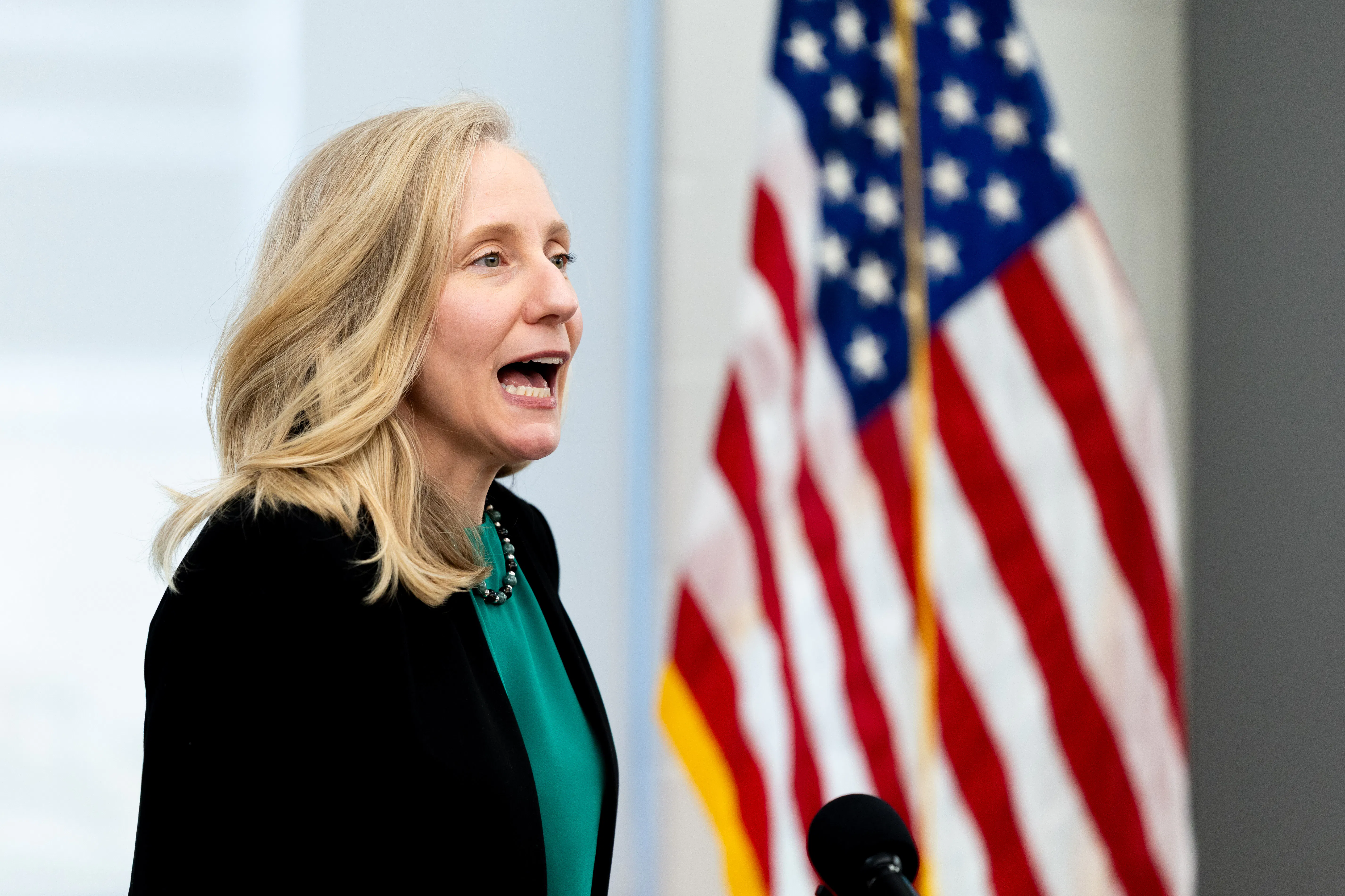 Gov. Abigail Spanberger speaks in front of an American flag