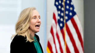 Gov. Abigail Spanberger speaks in front of an American flag