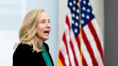 Gov. Abigail Spanberger speaks in front of an American flag
