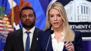 Attorney General Pam Bondi speaksk at a podium while FBI Director Kash Patel stands in the background