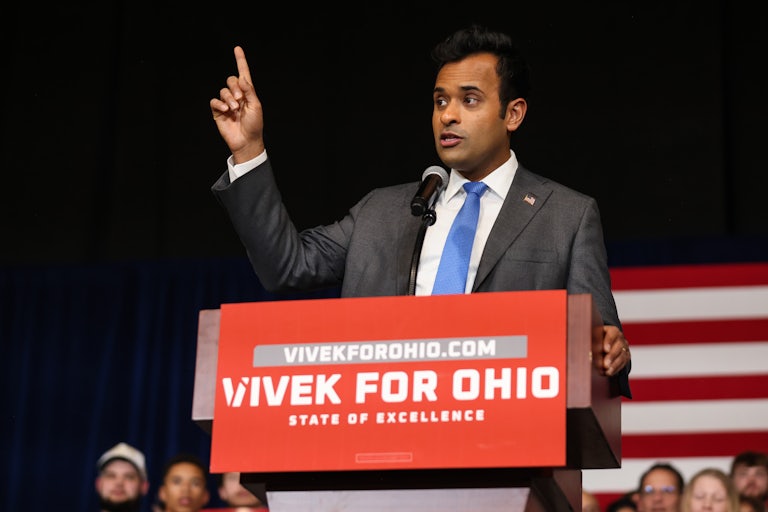 Vivek Ramaswamy raises his finger while speaking at a podium