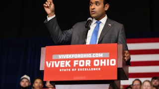 Vivek Ramaswamy raises his finger while speaking at a podium