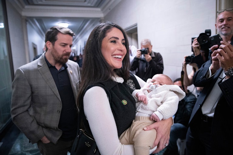Representative Anna Paulina Luna holds a newborn baby