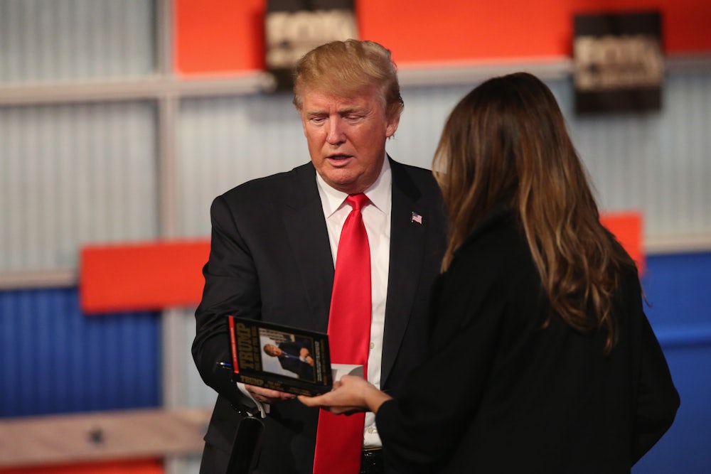 Trump holds a book