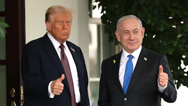 President Donald Trump and Israeli Prime Minister Benjamin Netanyahu both hold up thumbs up signs outside the White House.