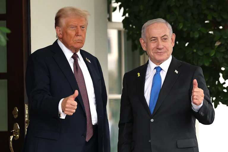 President Donald Trump and Israeli Prime Minister Benjamin Netanyahu both hold up thumbs up signs outside the White House.