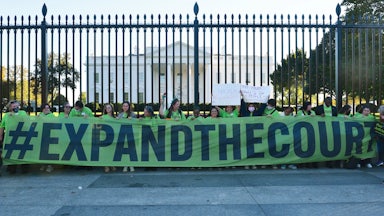 Volunteers with Demand Justice rally for seats to be added to the Supreme Court outside of the White House.