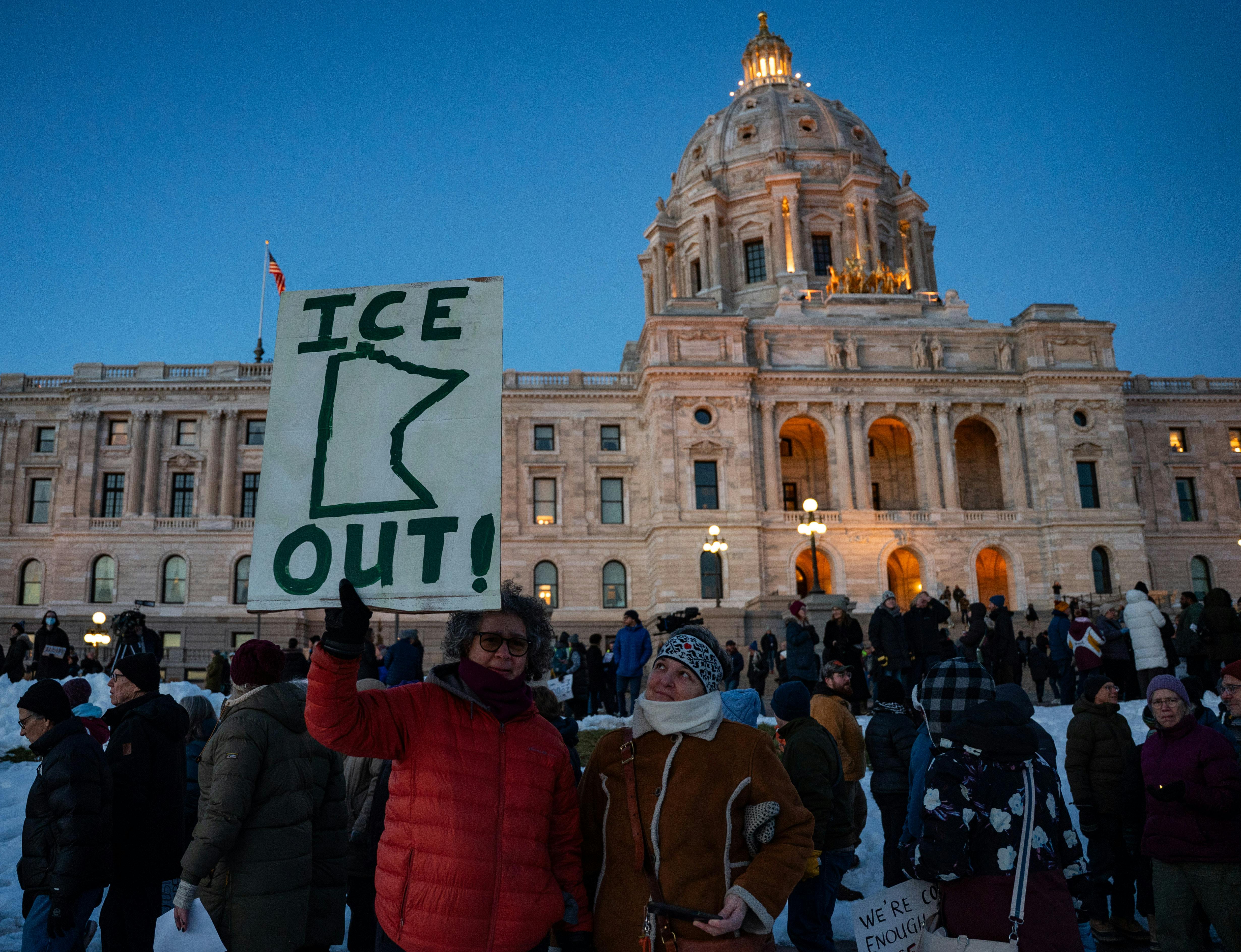 People protest against ICE outside the Minnesota state capitol in St. Paul