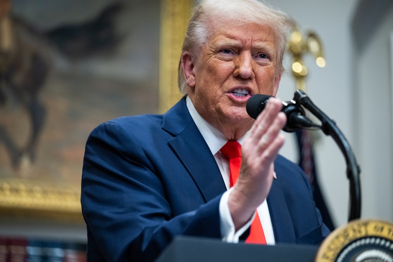 Donald Trump gestures while speaking at a podium during a White House press conference