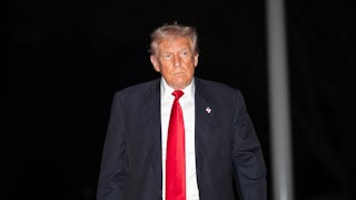 Donald Trump walks outside the White House