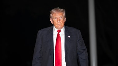 Donald Trump walks outside the White House