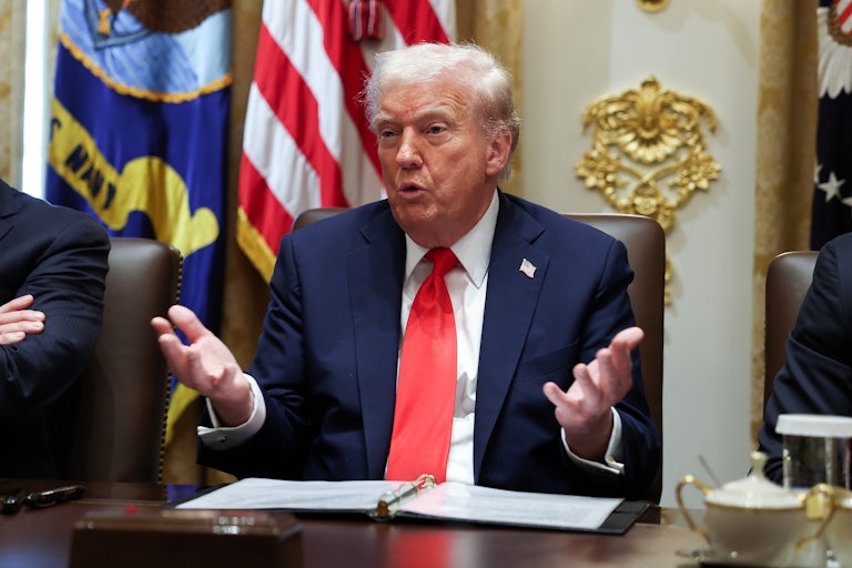 Donald Trump holds his hands out while speaking during a Cabinet meeting