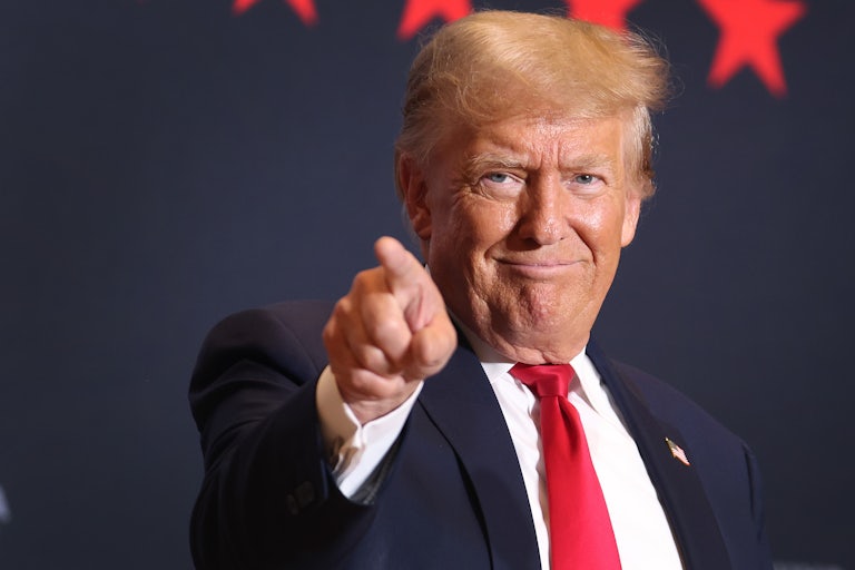 Donald Trump smiles and points