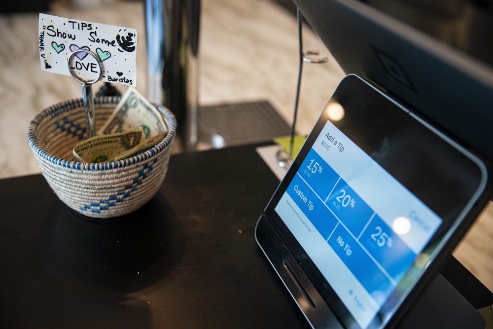 A tip screen displays three options for tipping, with a tip basket next to the screen.