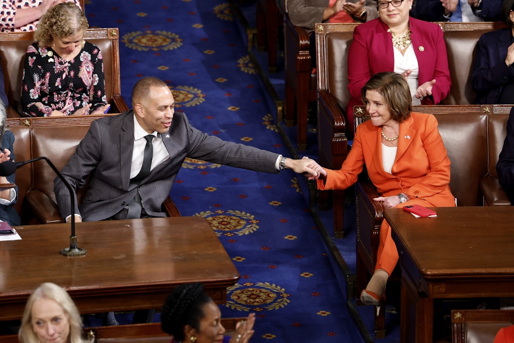 House Minority Leader Hakeem Jeffries holds hands with Rep. Nancy Pelosi