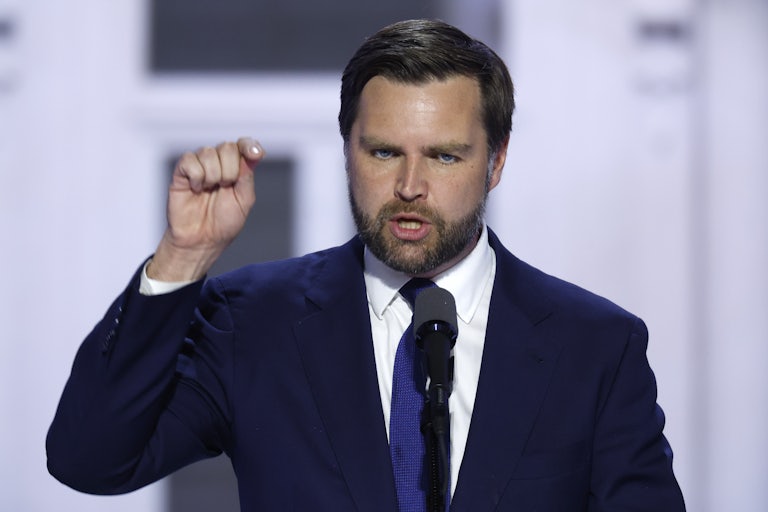 J.D. Vance speaks angrily at a lectern and points