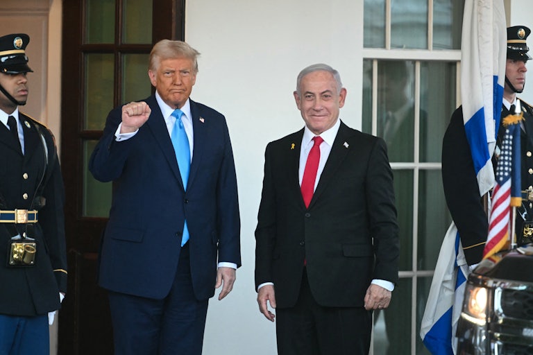 Donald Trump raises a fist while Israeli Prime Miniser Benjamin Netanyahu smiles weirdly. Both stand outside the White House on Netanyahu’s recent visit.