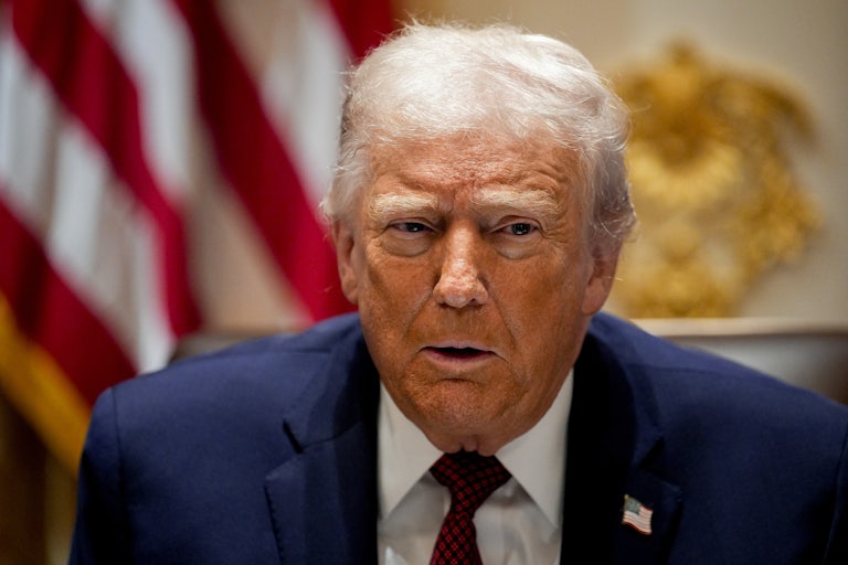 Donald Trump speaks while sitting in the White House Cabinet Room