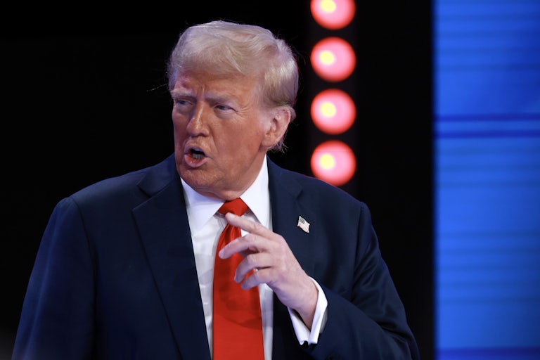 Donald Trump looks to the side and gestures while speaking during a town hall hosted by Univision