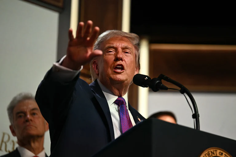 Donald Trump speaks at a podium