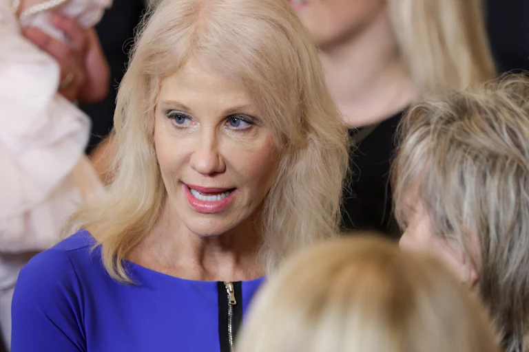 Kellyanne Conway speaks while standing int he crowd during an event