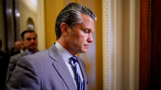 Defense Secretary Pete Hegseth looks down while walking in the Capitol