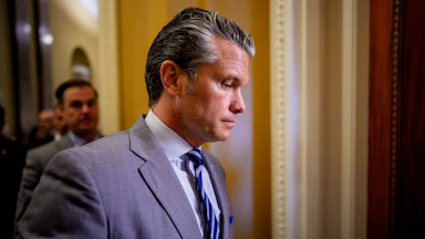 Defense Secretary Pete Hegseth looks down while walking in the Capitol