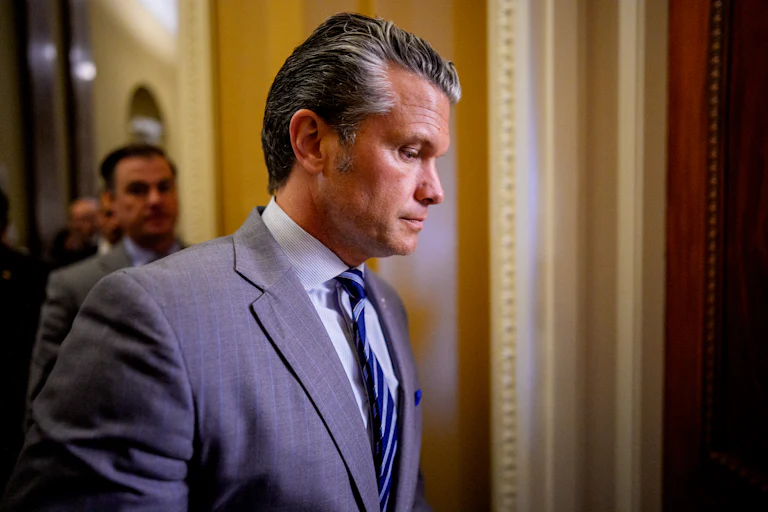 Defense Secretary Pete Hegseth looks down while walking in the Capitol