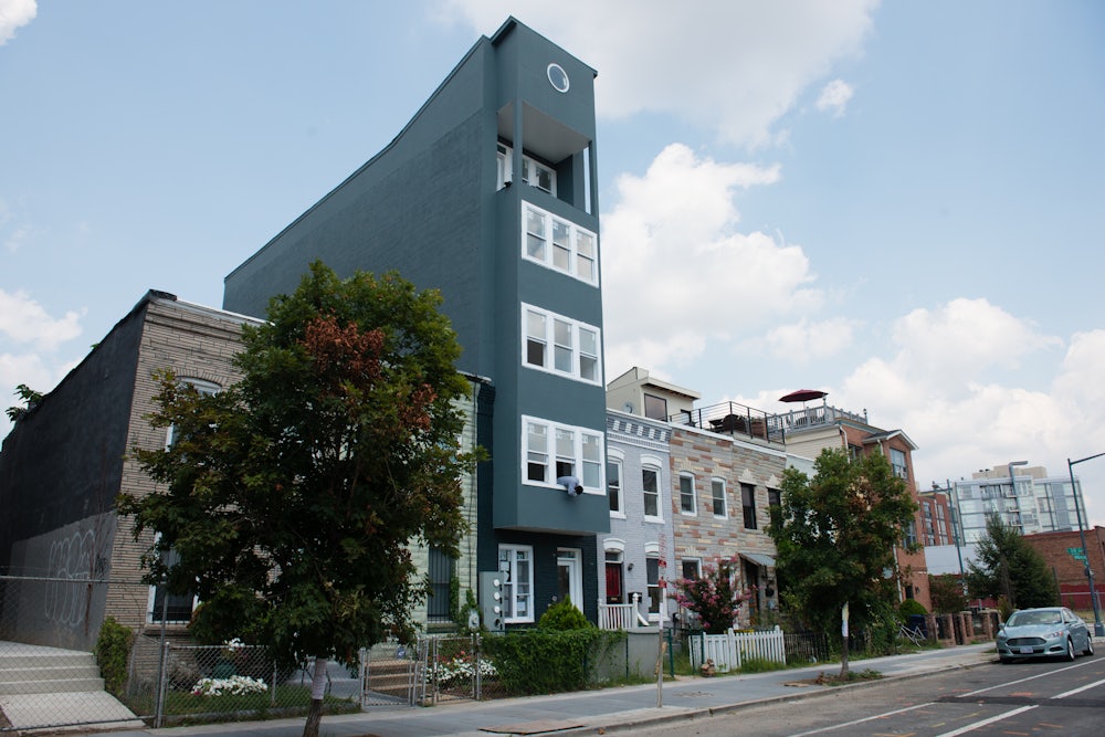 A two-story row house converted into a five-story condo building