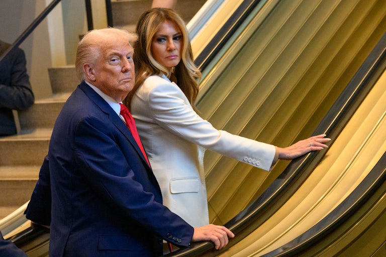 Donald and Melania Trump stand on an escalator in the United Nations headquarters