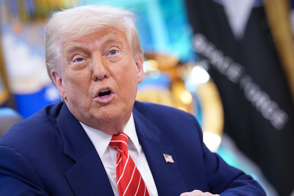 Close up of Donald Trump sitting in the Oval Office.