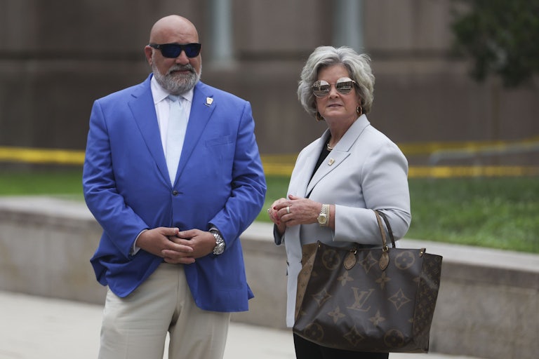 Trump advisers Chris LaCivita and Susie Wiles stand outside, both wearing sunglasses