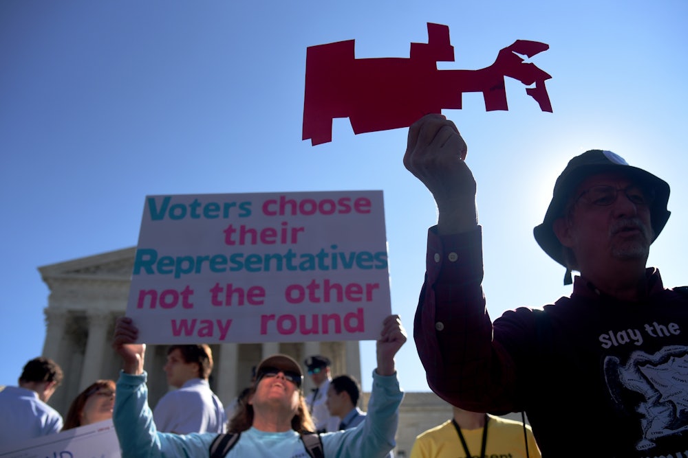 A demonstrator holds up a cutout of a gerrymandered district as protestors gather outside the Supreme Court. The high court has been resistant to the entreaties of reformers.