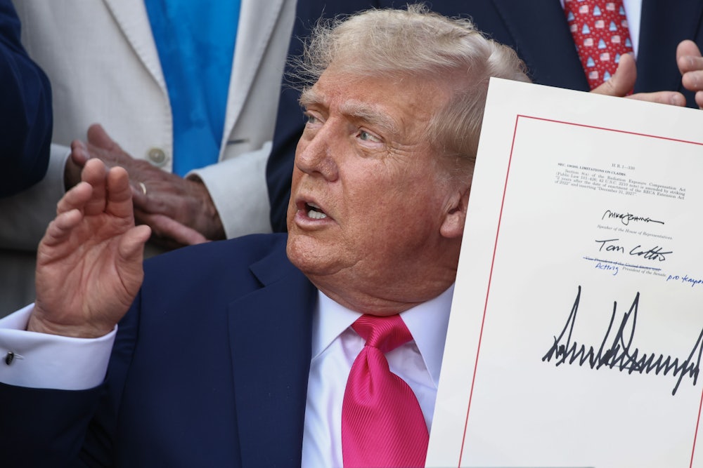 Donald Trump signs the Republican budget bill into law on the South Lawn of the White House. Nearly 14 million Americans will lose their health care as a result.