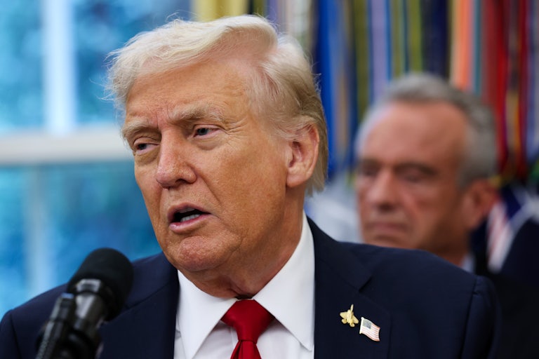 Donald Trump speaks into a microphone during a press conference