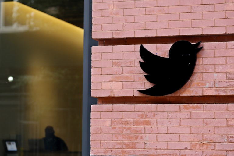 Twitter logo on brick wall