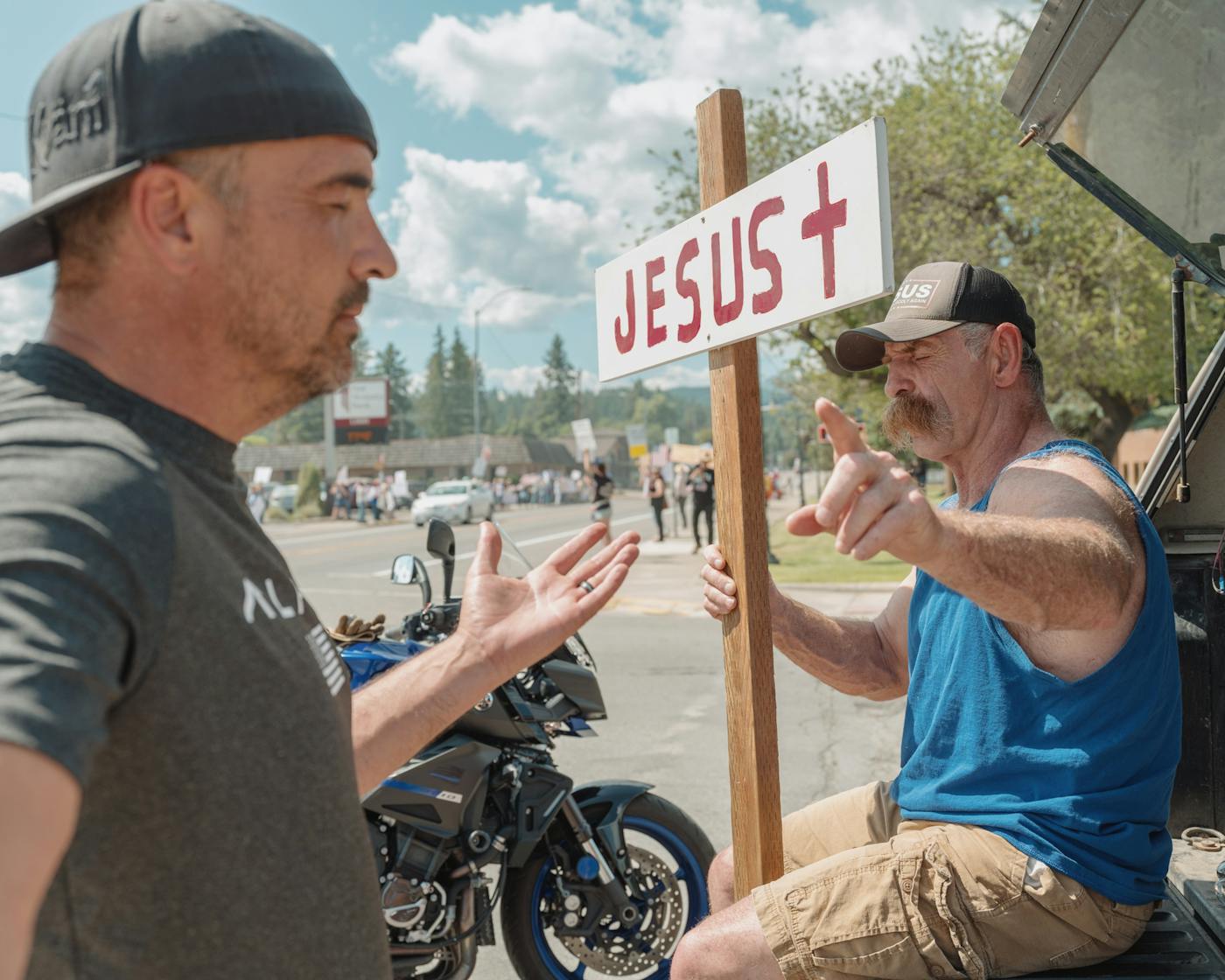 James Monre, a local preacher prays with a friend during the No Kings rally in Libby Montana on June 14