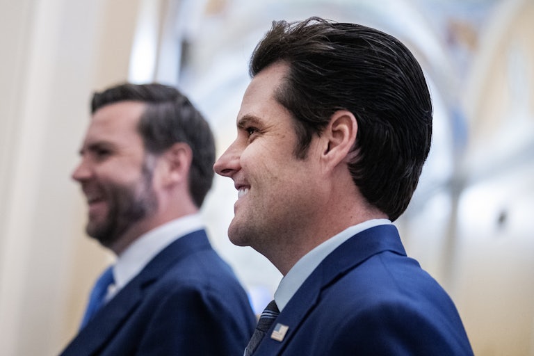 Matt Gaetz is seen in profile as he walks through the Senate with JD Vance