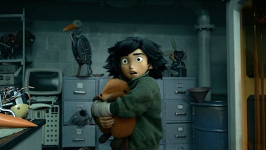 A person wraps her arms around a small, furry animal, while standing in a dark interior surrounded by file cabinets and old m