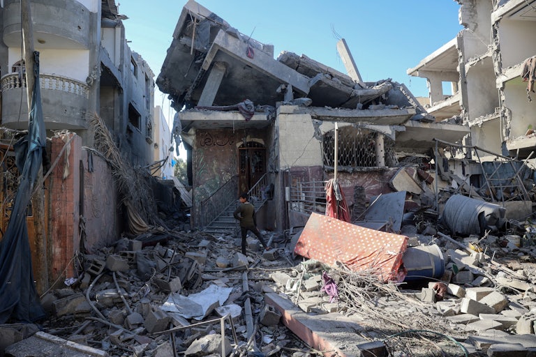 A Palestinian child stands amid the destruction following an Israeli strike in the Bureij refugee camp in the central Gaza Strip on November 17, 2024, amid the ongoing war between Israel and the Hamas militant group.