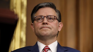 House Speaker Mike Johnson frowns during a press conference