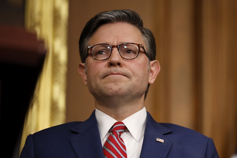 House Speaker Mike Johnson frowns during a press conference