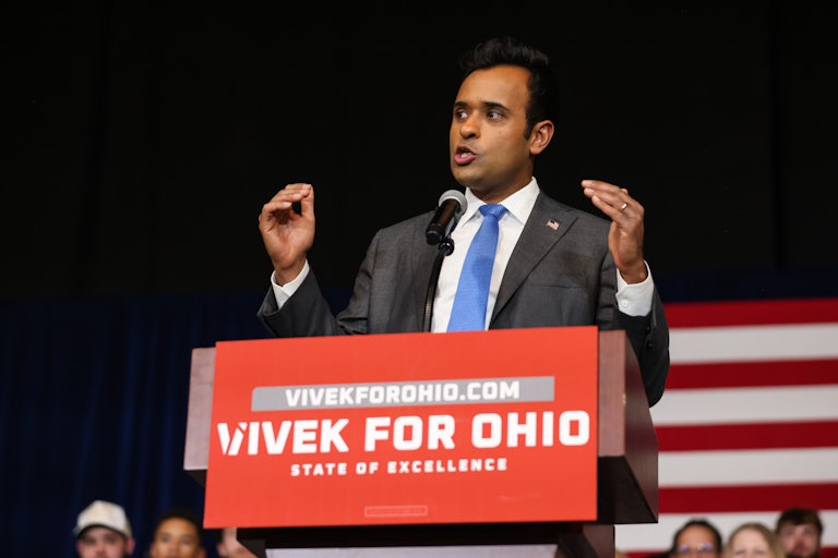 Vivek Ramaswamy gestures while speaking at a podium during a campaign event
