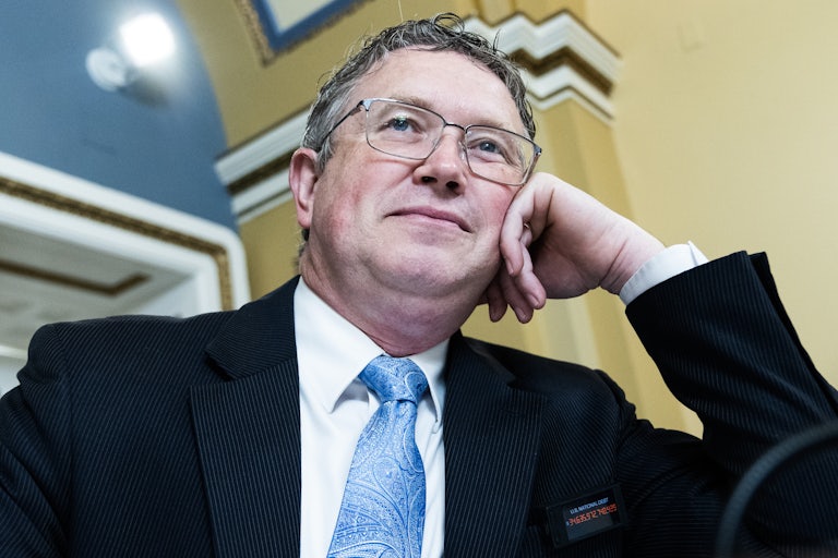 Representative Thomas Massie rests his cheek on his hand during a House committee hearing
